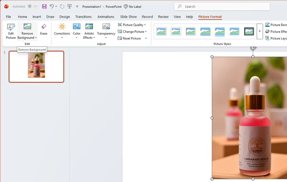 PowerPoint with a photo of a serum bottle selected and the Picture Format tab open, with Remove Background at the left